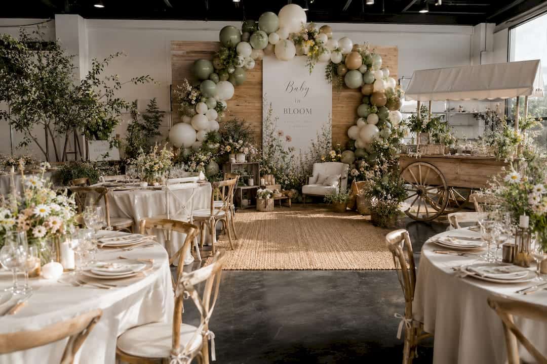 Event designer building balloon arch frame indoors