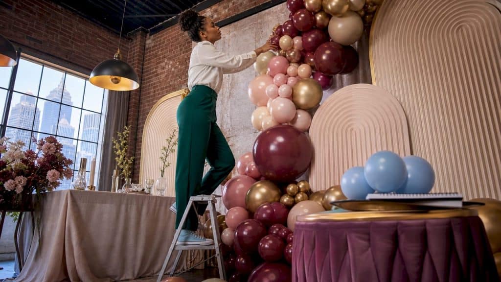 Event designer installing luxury balloon garland