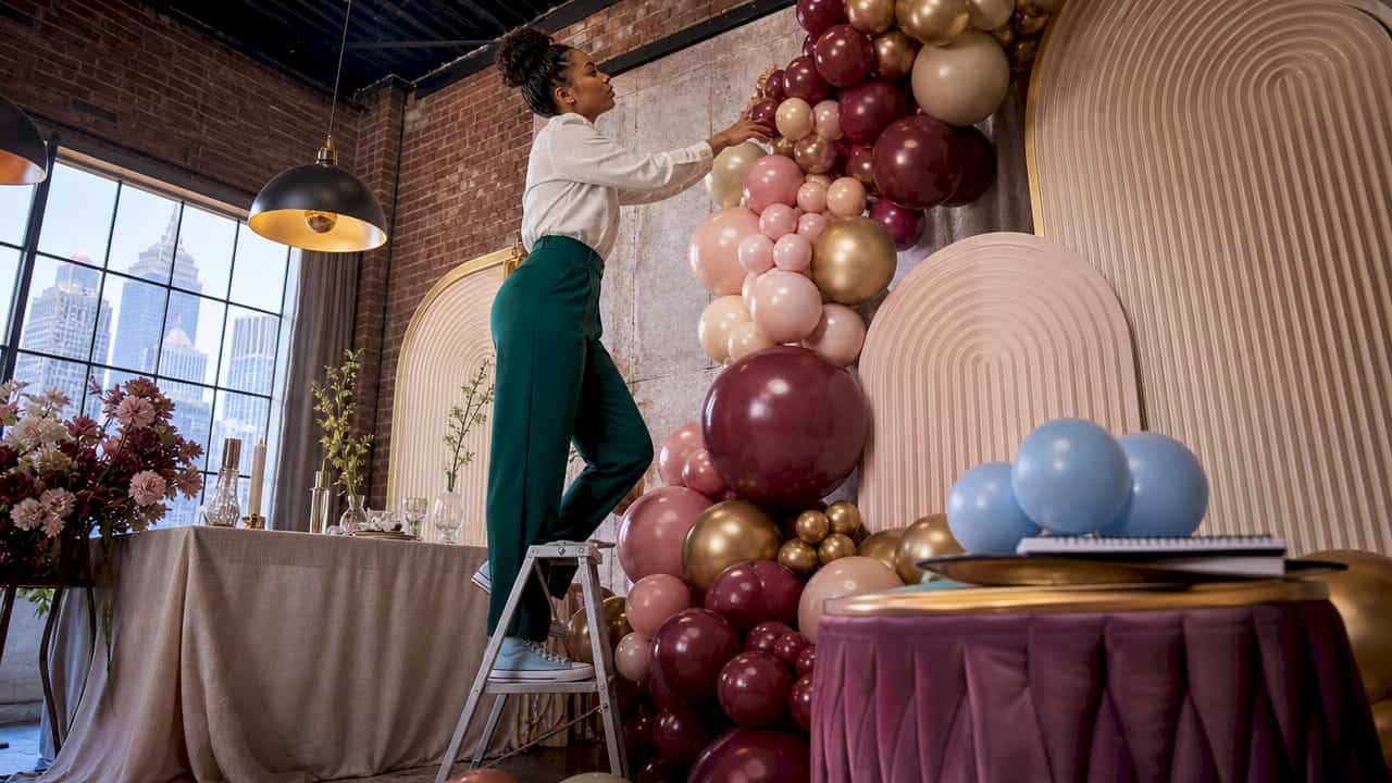 Event designer installing luxury balloon garland