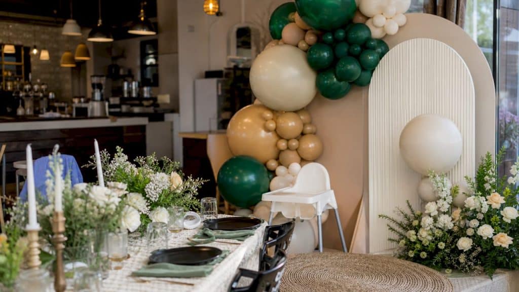 First Birthday Party Planning: A New Parent's 2026 Guide Luxurious first birthday party setup with balloons and floral decor