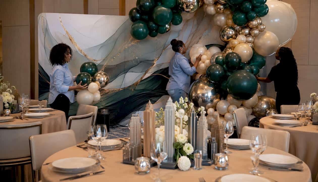 The Role of Graphics in Event Decor for Atlanta Luxury Events Luxury balloon arch integrated with printed backdrops in venue