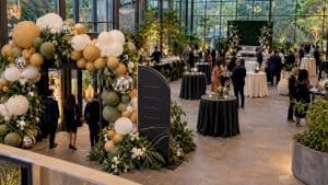 Balloon welcome arch beside event wayfinding sign