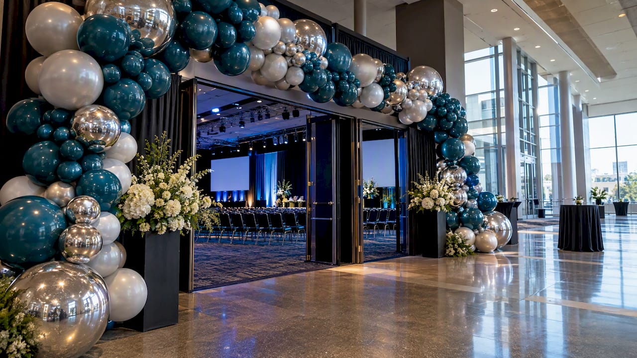 12 Camera Ready Conference Entrance Decor Ideas for Planners 1 Conference entrance with balloon decor and AV lighting
